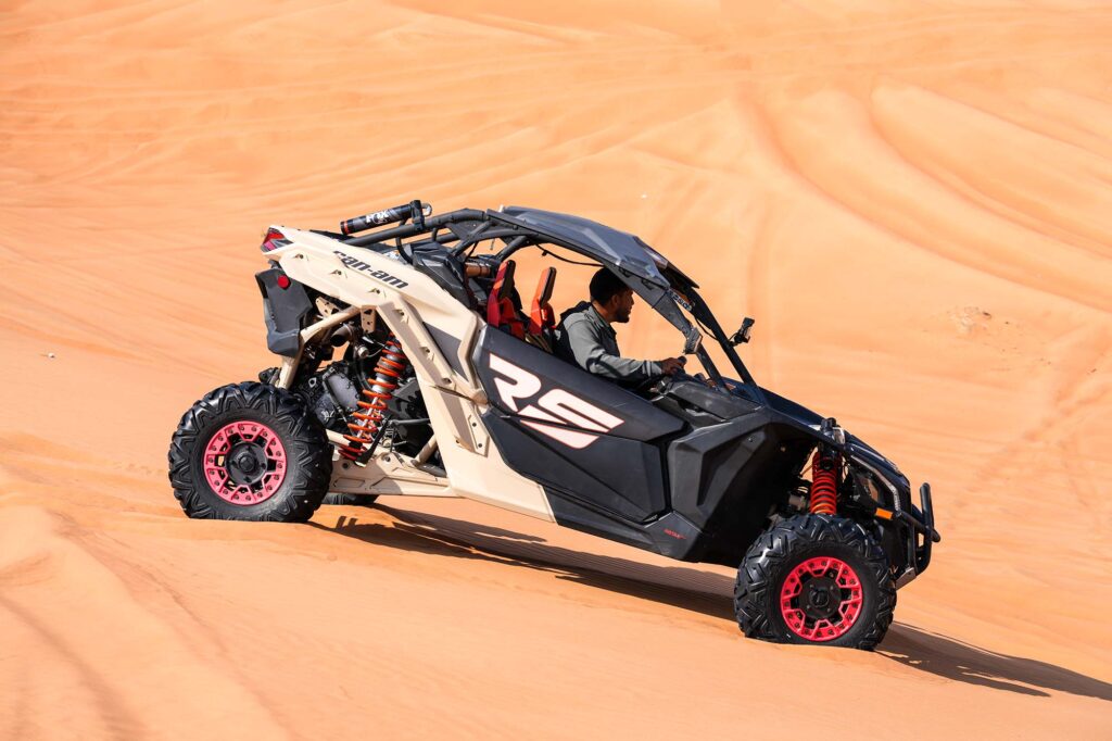 Guided desert safari riding through Lahbab dunes
