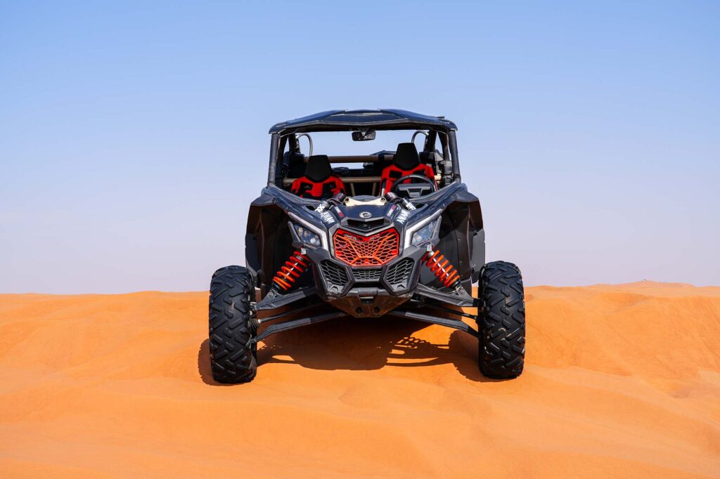 Can-Am buggy sitting in soft sand dunes Dubai