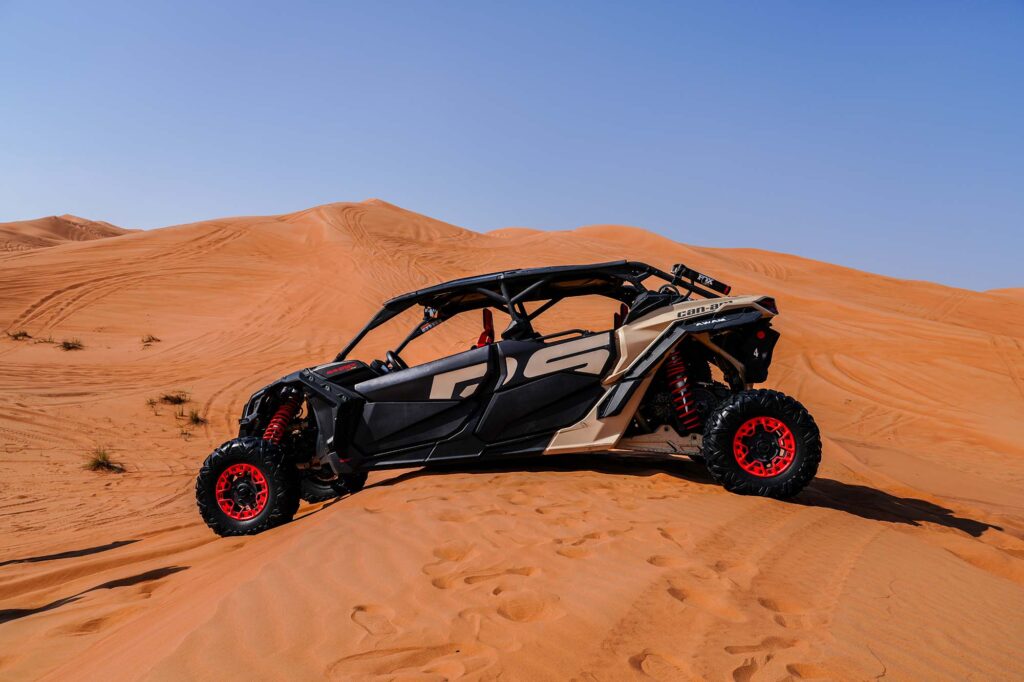 Can-Am buggy in red sand dunes Dubai