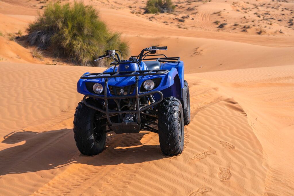 Rider stopping quad bike for desert photo opportunity Dubai