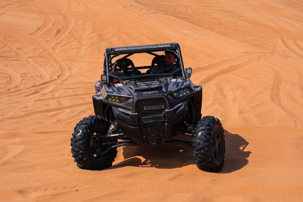 Single driver Polaris buggy driving in Dubai sand dunes