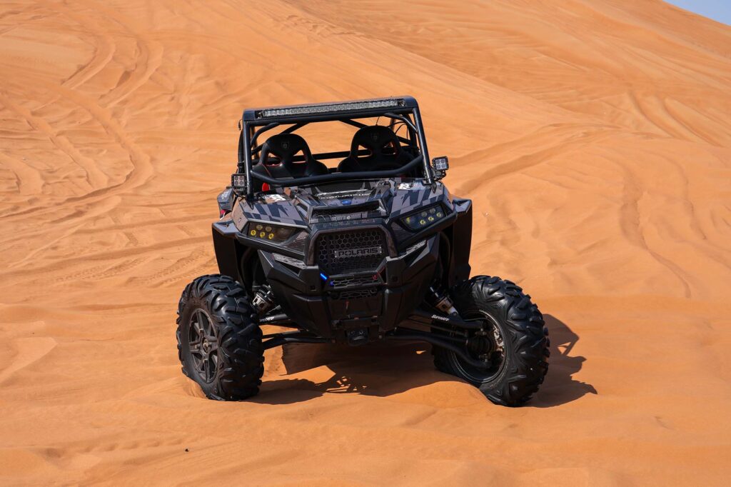 Polaris 2 seater buggy parked in Dubais sand dunes